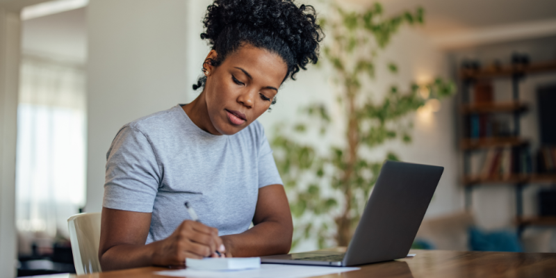 Woman writing on a notepad