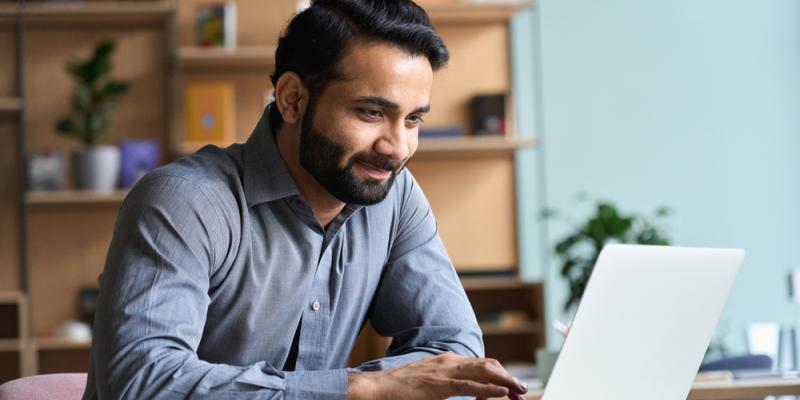 Man scrolling on laptop